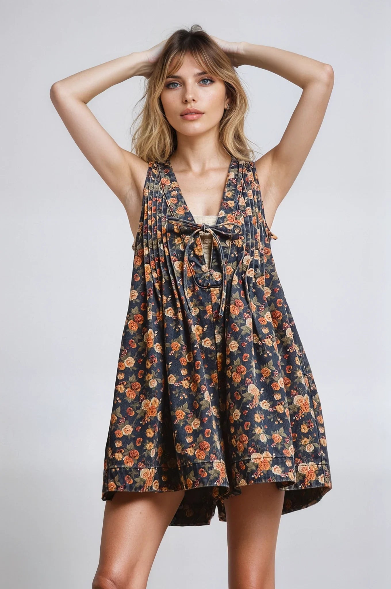 Woman wearing a floral dress against a plain background